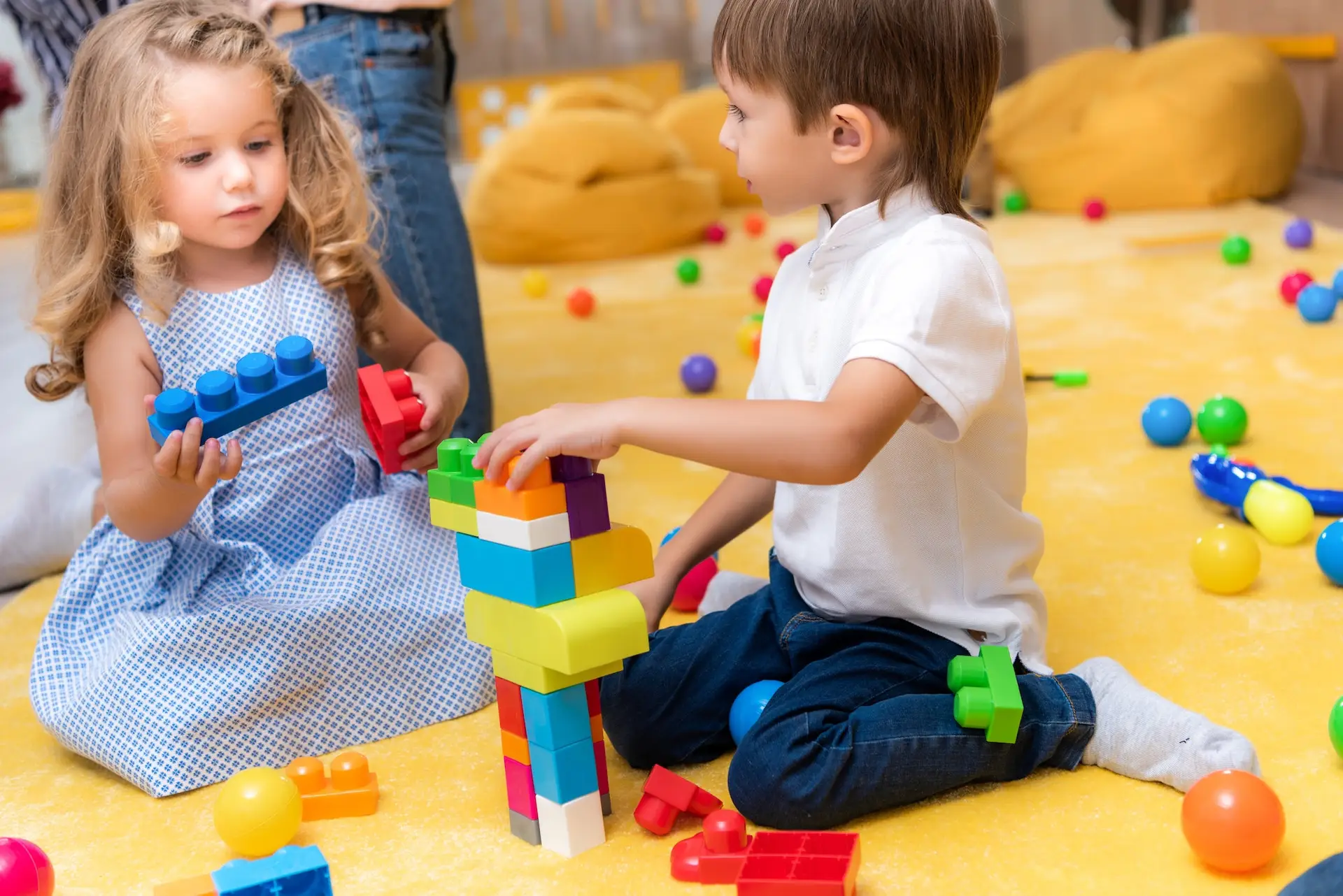 Adorable children playing with constructor in kindergarten